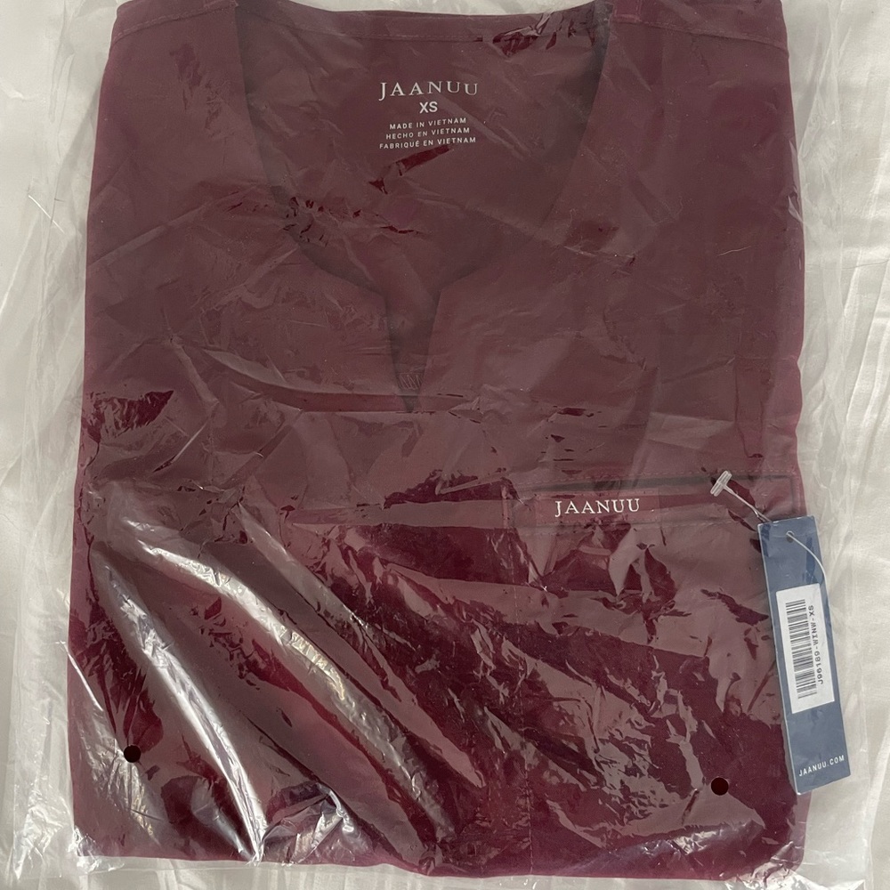 Jaanuu 3 pocket notch scrub top. Wine red